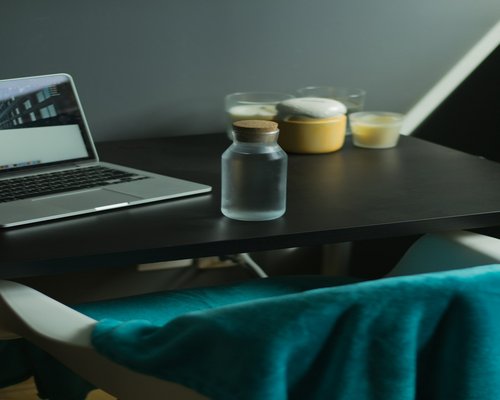 Glass of water with fresh lemon slices on a desk